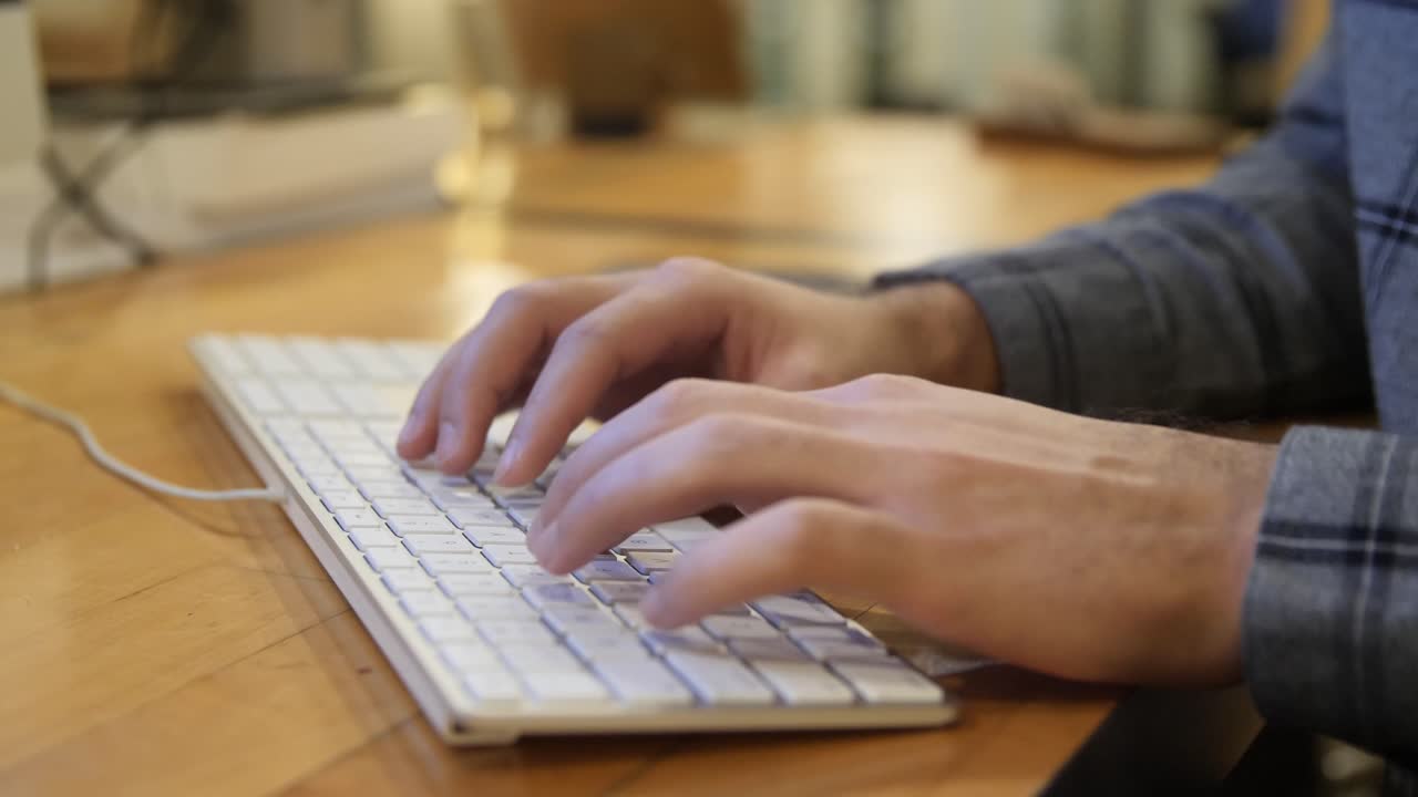 Male hands typing on a keyboard