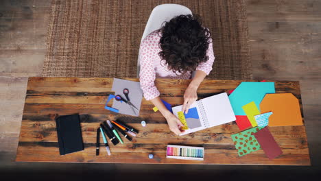 woman crafting at a wooden table