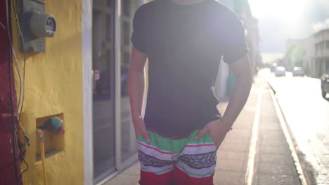 man in colorful shorts on city street