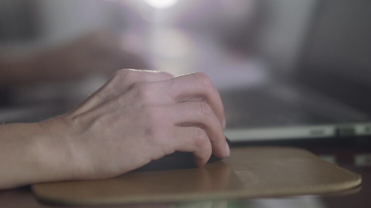 Closeup shot of woman's hand, clicking her mouse