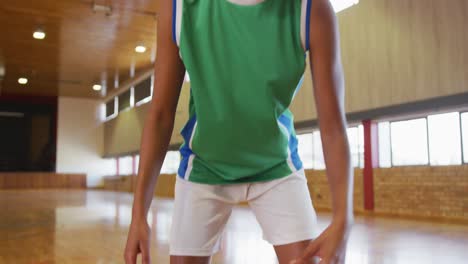 african american female basketball player dribbling and shooting with ball