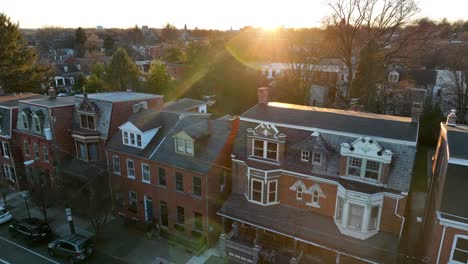 slow, cinematic aerial rising shot of old, historic homes in american city