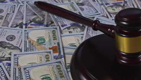 legal justice desk on wooden judgment gavel with police handcuffs of many currency cash us dollars