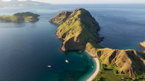 Tour-boats-visit-South-Padar-island-in-Indonesia-east-of-Komodo,-Aerial-orbit-around-shot