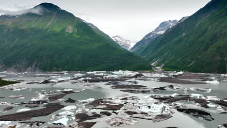 Alaska stunning glacier views. Vast ice formations contrast with green mountains under cloudy skies in Alaska, showcasing nature&#039;s breathtaking beauty
