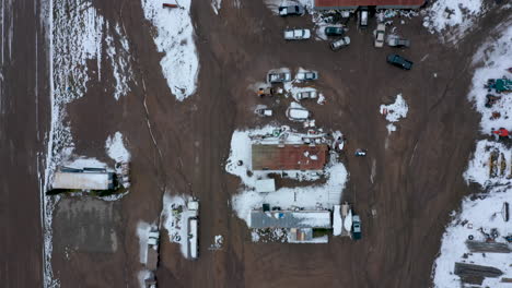 Rising-over-a-wintery,-snowy-farm-in-Tehachapi,-CA