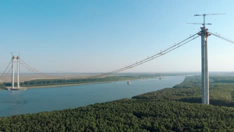 cranes on the main tower of the braila bridge over danube river in romania