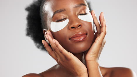 Face,-skincare-and-black-woman-with-eye-patches