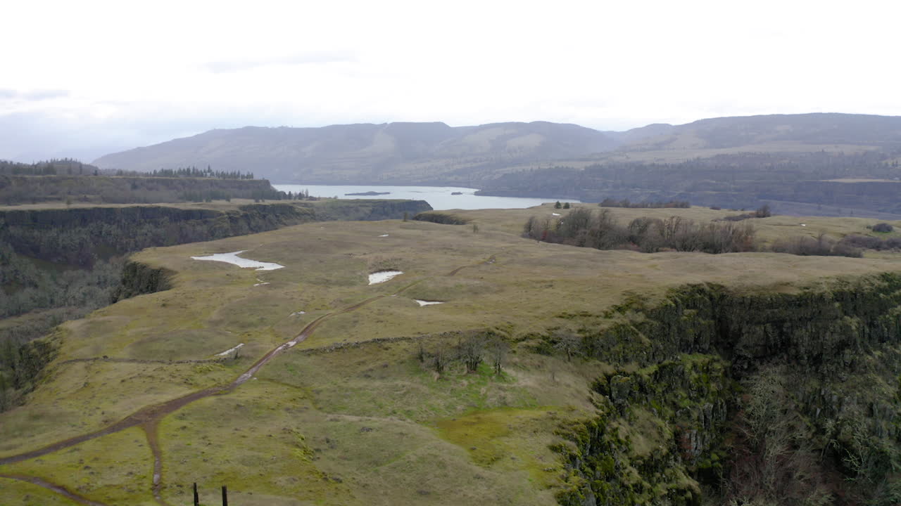 Expansive Overcast Landscape of a River Gorge and Plateau