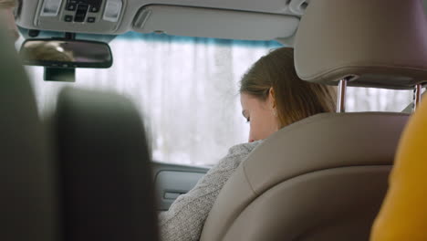 Portrait-Of-Smiling-Woman-Sitting-On-Passenger-Seat-In-A-Car-Talking-To-Her-Friends