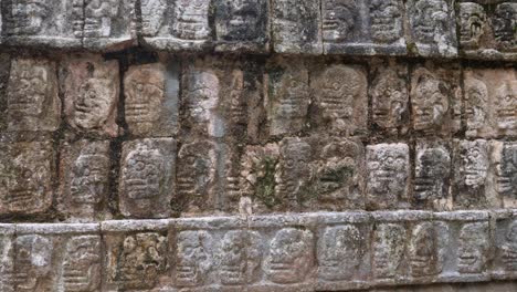 the platform of the skulls (tzompantli) detail of the bas-relief, at chichen itza archaeological site.