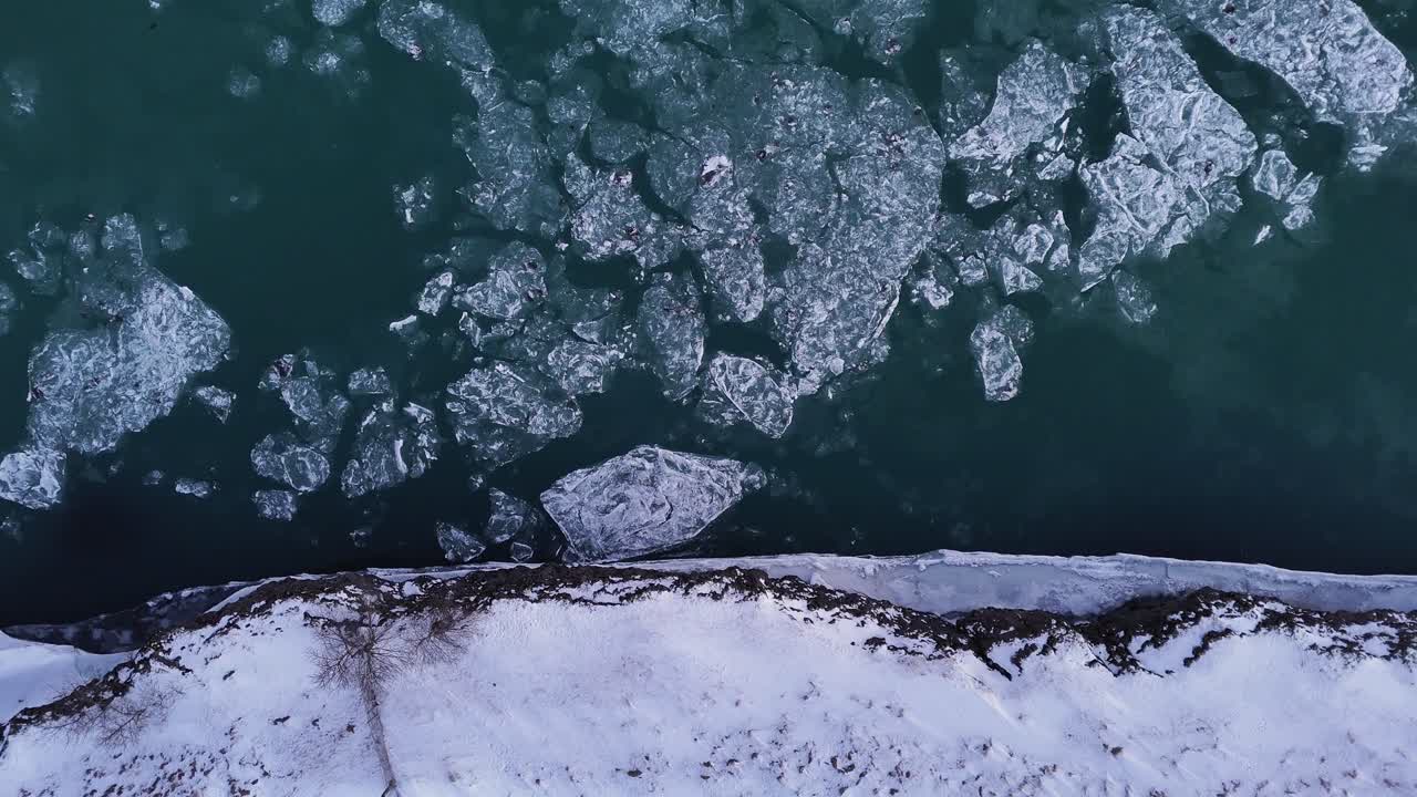 Melted Ice Drifting Over River Surface In South Iceland. Aerial Topdown Shot