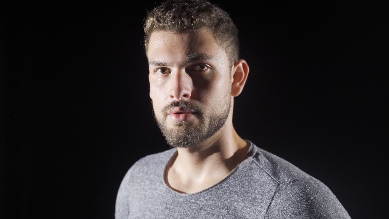 el cuerpo de un joven mirando a la cámara.