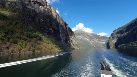 view from moving ferry on motor boat crossing the geiranger fjord in norway