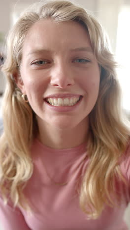vertical video of portrait of caucasian woman talking and having video call at home, slow motion