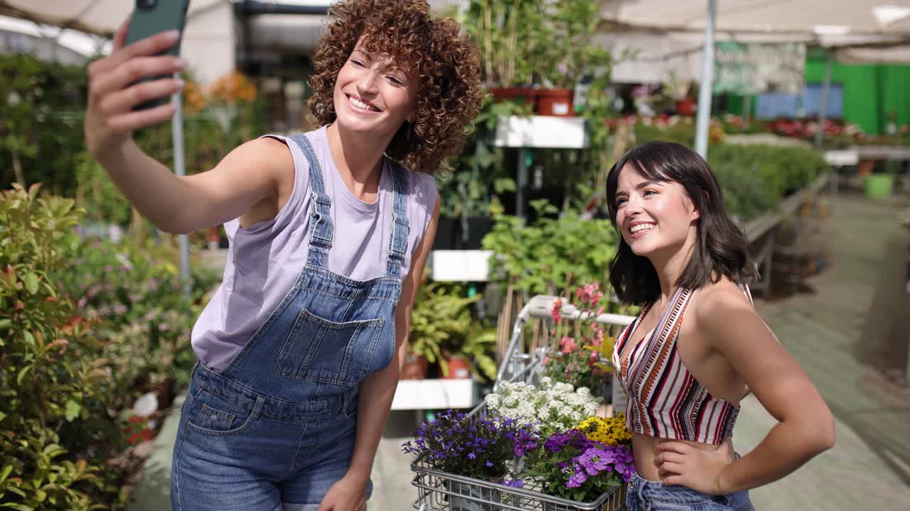Garden center fun: friends taking selfies with flowers
