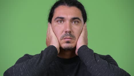 handsome man covering ears as three wise monkeys concept