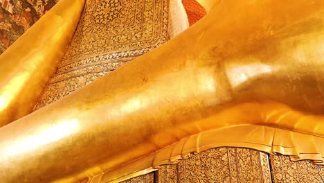 golden buddha statue in serene, reclining position