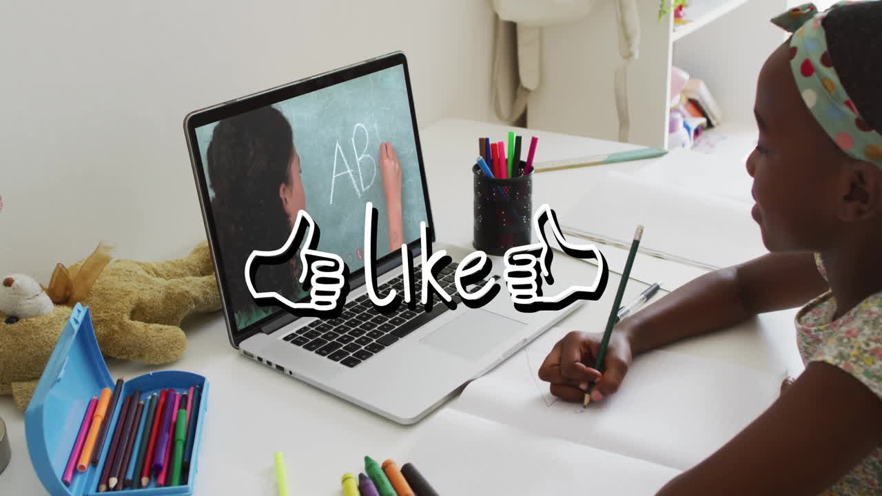 In school, child learning online with animation on laptop, colorful stationery nearby