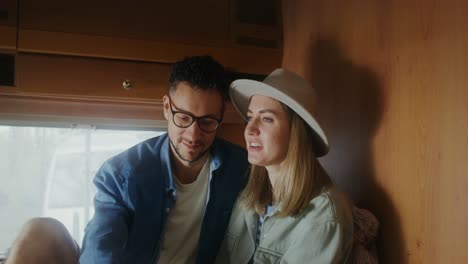 couple relaxing in a camper van