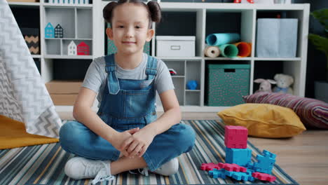 girl playing in playroom with puzzle blocks