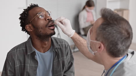 medical worker taking sample of saliva