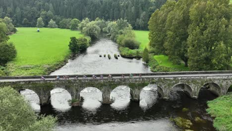 kilkenny inistioge cycle race crossing the picturesque bridge over the river barrow on a summer morning