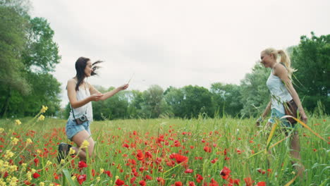 two women enjoying a poppy field