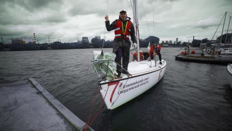 sailors working on a yacht at a marina