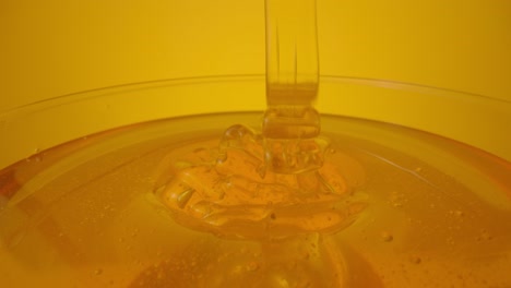 honey pouring into bowl