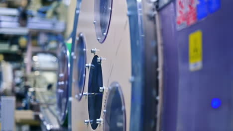 big round rotating mechanism at the diaper production factory. a number of working devices at the backdrop.