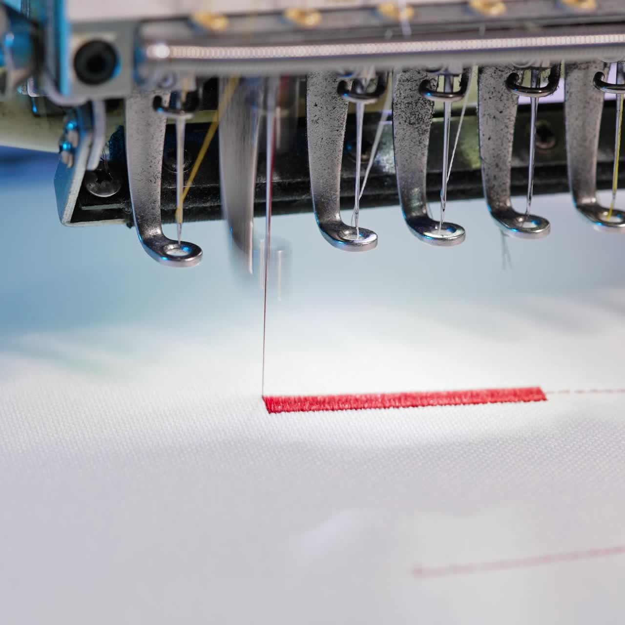 Automatic professional embroidery machine. Automatic embroidery machine working at high speed in factory