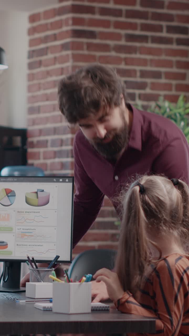 Child with Father in Office Looking at Graphs on Computer