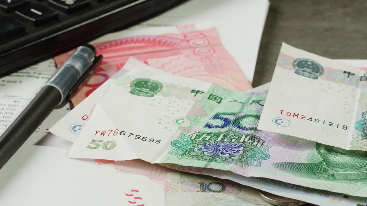 Chinese Yuan Bills, Calculator, and Documents