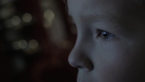 boy watching tv in the darkness