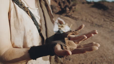 dystopian woman looking at dusty hands