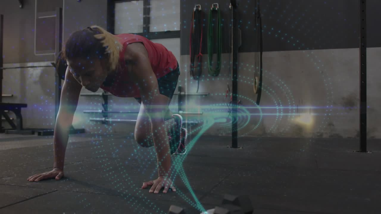 Woman starting high plank driving knees in gym, teal hologram aligning with legs for core strength