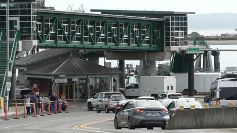 vehicles driving towards the ferry boarding area at bainbridge island terminal, preparing for maritime travel.