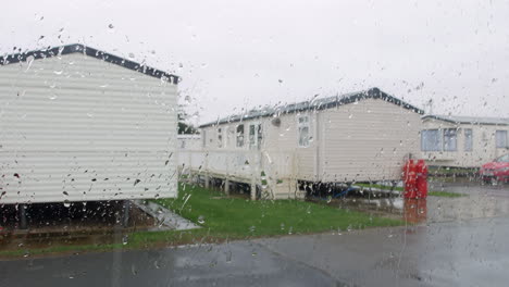 rain falling on a caravan trailer vacation camp on a wet raining staycation at a british holiday seaside resort