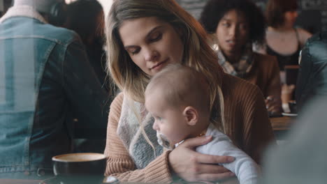 young mother caring for baby in cafe using pacifier nurturing child relaxing in busy restaurant enjoying motherhood