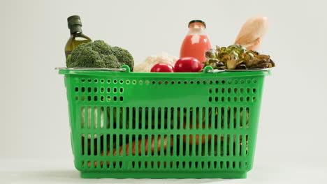 shopping basket filled with fresh produce and juice