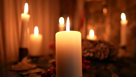 many candles burning in slow-motion in the dark, romantic vibe or festive decorations for christmas or a birthday