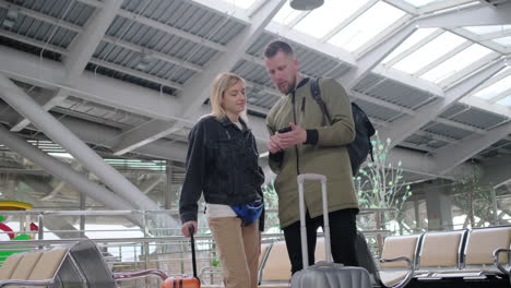 couple using phone at airport