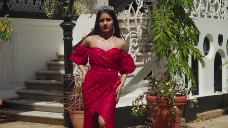 Within-the-fortress-like-confines-of-a-Caribbean-castle,-a-young-woman-in-a-red-gown-evokes-timeless-beauty