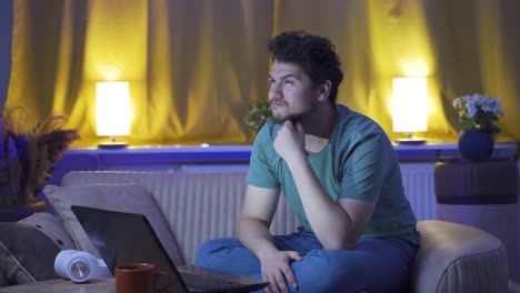 man thinking about a topic at night at home.