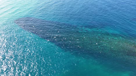 hexagonal rock formations in clear blue water