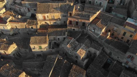 top down view of historic city modica at sicily during sunrise, aerial