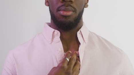 man posing and touching his skin with his finger