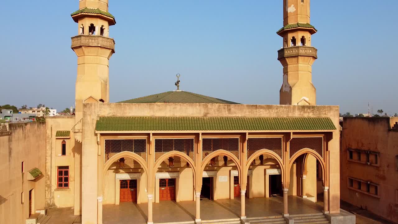 Aerial static establishing shot of Banjul city's main central mosque facade, King Fahd with beautiful minarets