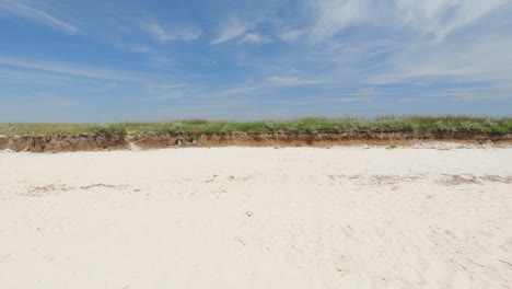 view across the sand to a small canyon and green grass. beautiful summer landscape